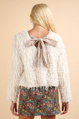 LONG SLEEVE FRINGE SWEATER WITH VELVET BOW DETAIL